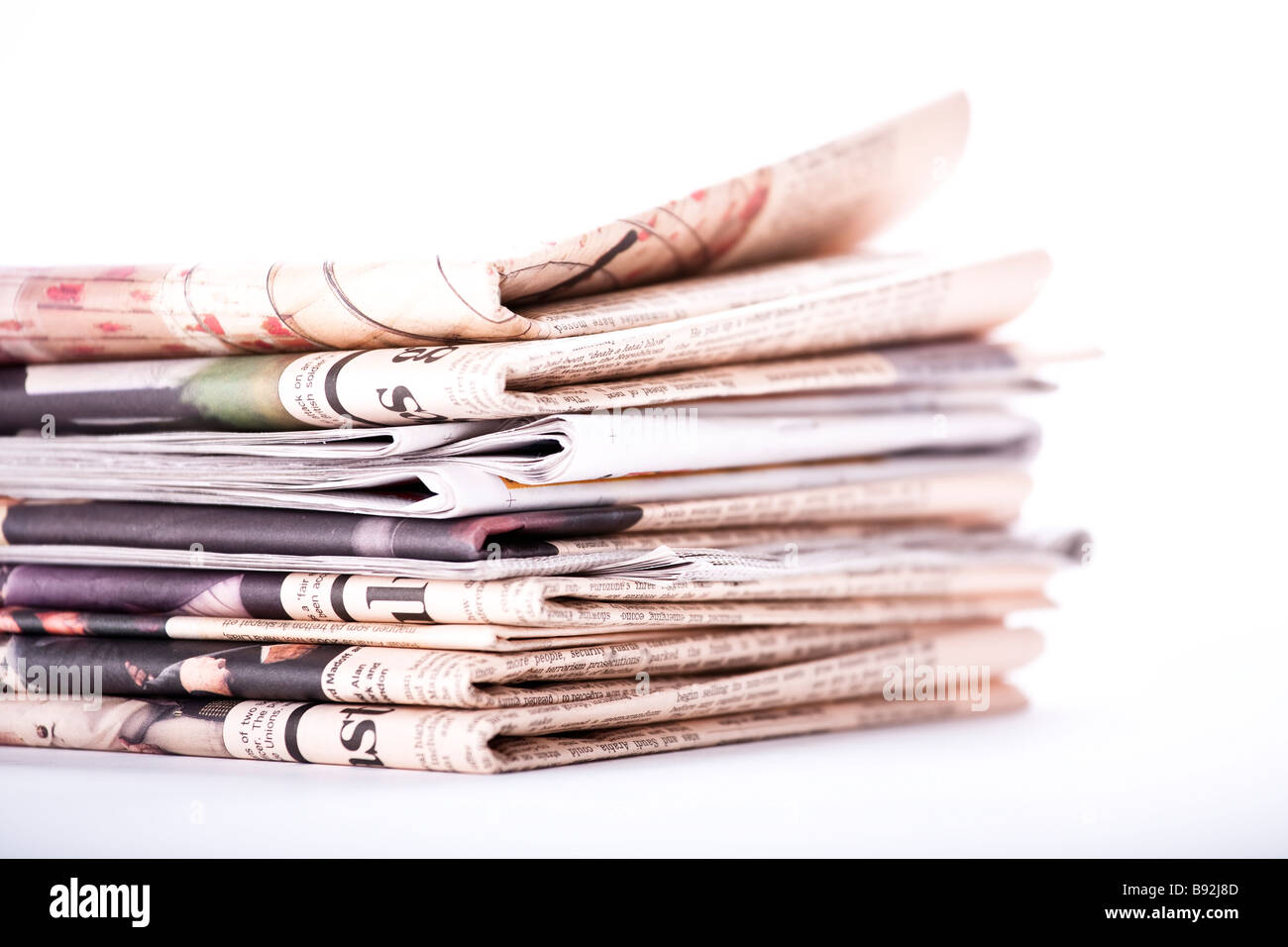 Pile of newspaper on white background Stock Photo Alamy