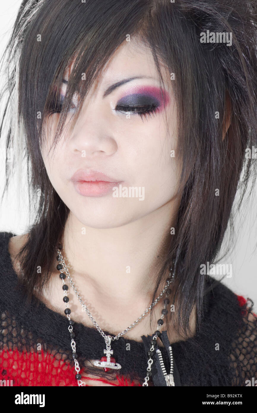 Young japanese woman in style of visual kei with black red clothing and vivid makeup Stock Photo
