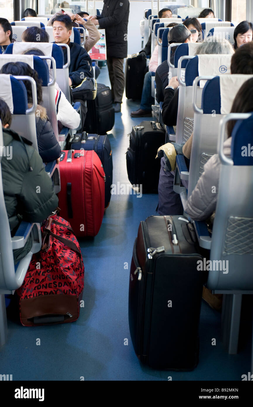 Passengers and luggage inside carriage on new Airport Express railway line to Terminal at Beijing International Airport 2009 Stock Photo