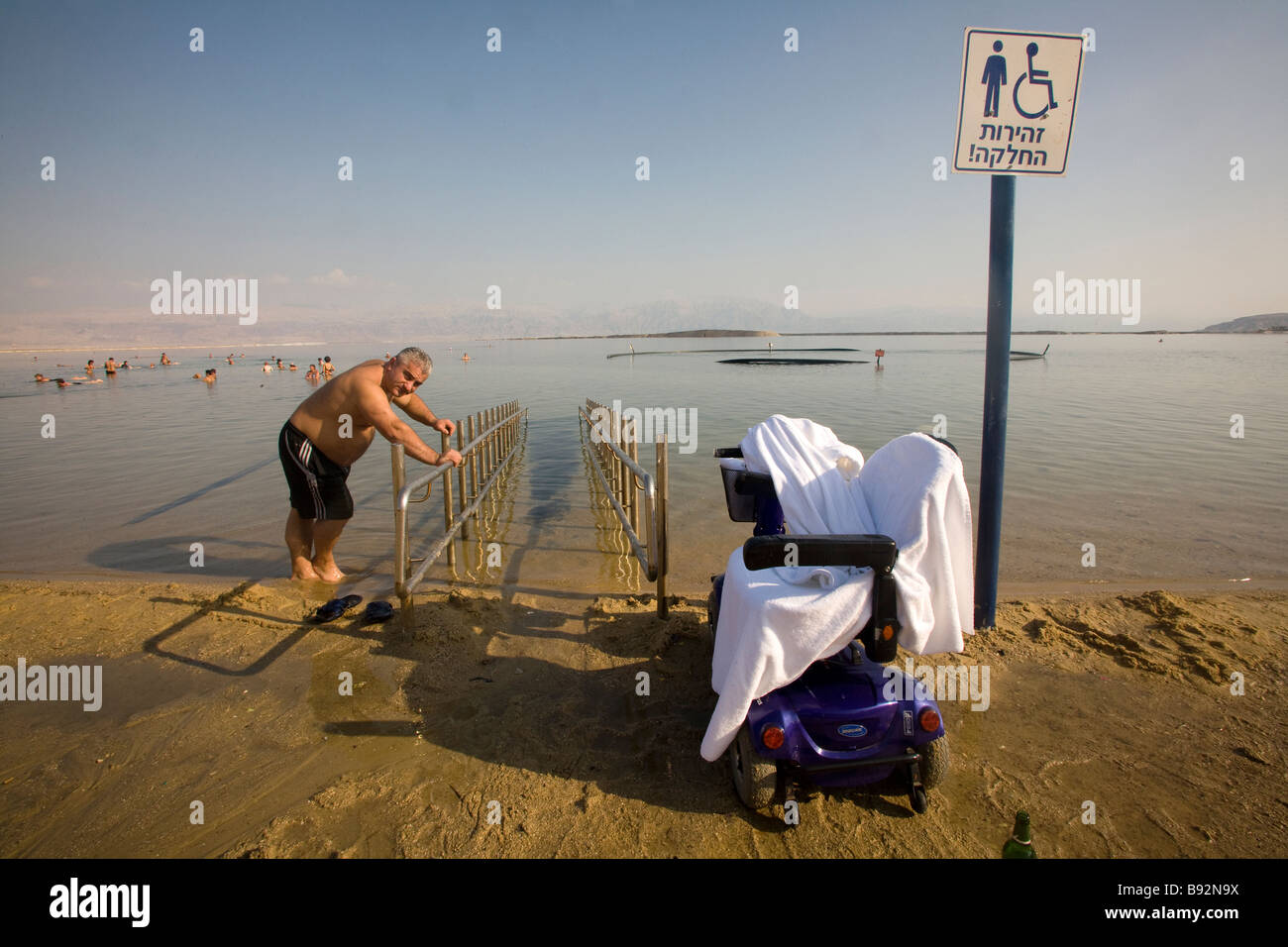 Man leaning against disability ramp in Dead Sea, Israel, Middle East Stock Photo