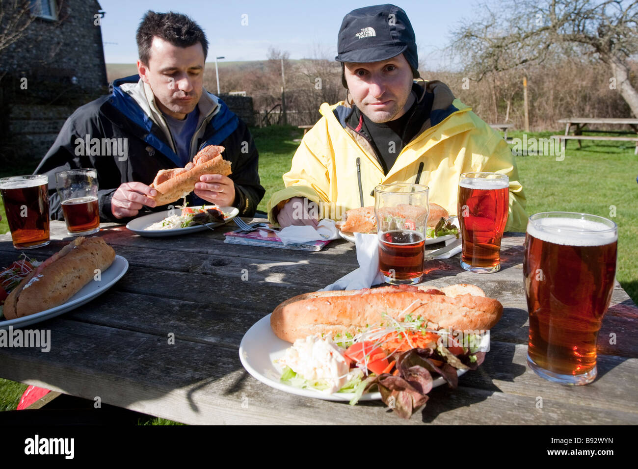 Walkers having a pub lunch in The Trevor Arms. Glynde, Near The South Downs Way, East Sussex, England, UK Stock Photo