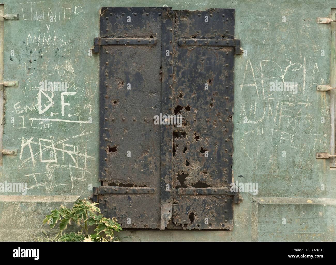 old iron door with green wall and grafitti Stock Photo - Alamy