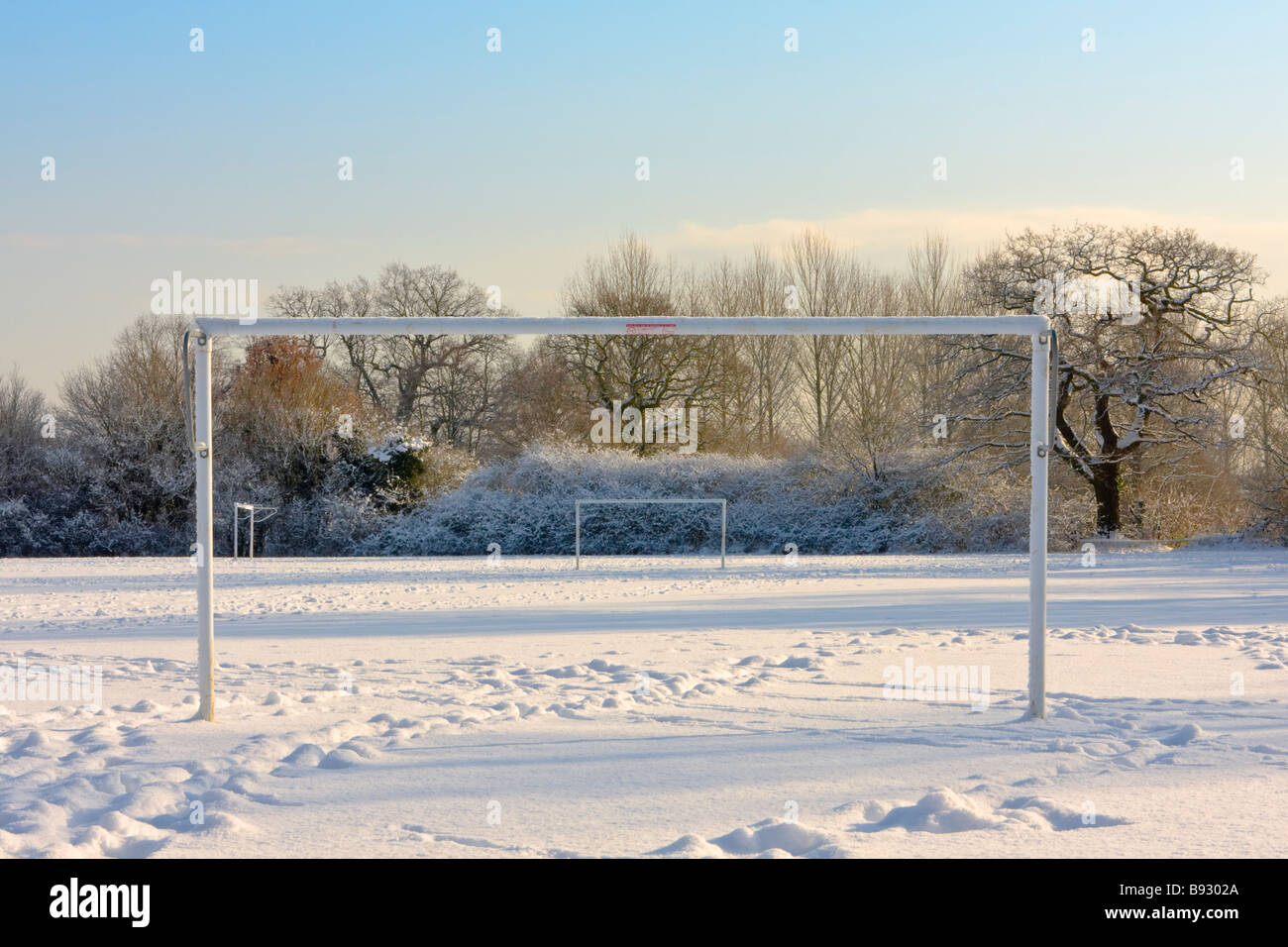 Hockey goal posts and snow covered pitch Stock Photo
