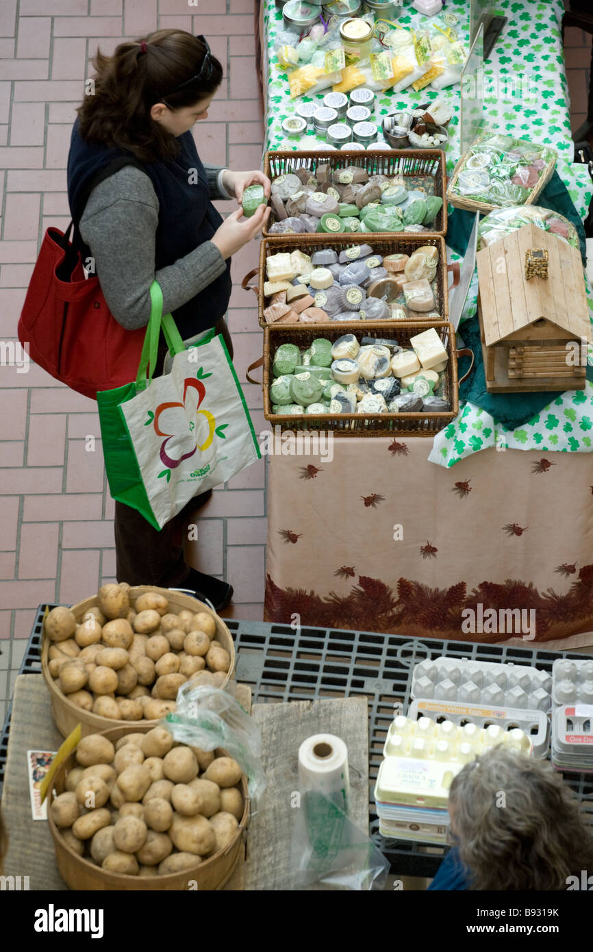 Woman sampling home made soaps at Farmers Market every Saturday year round in Troy New York Stock Photo