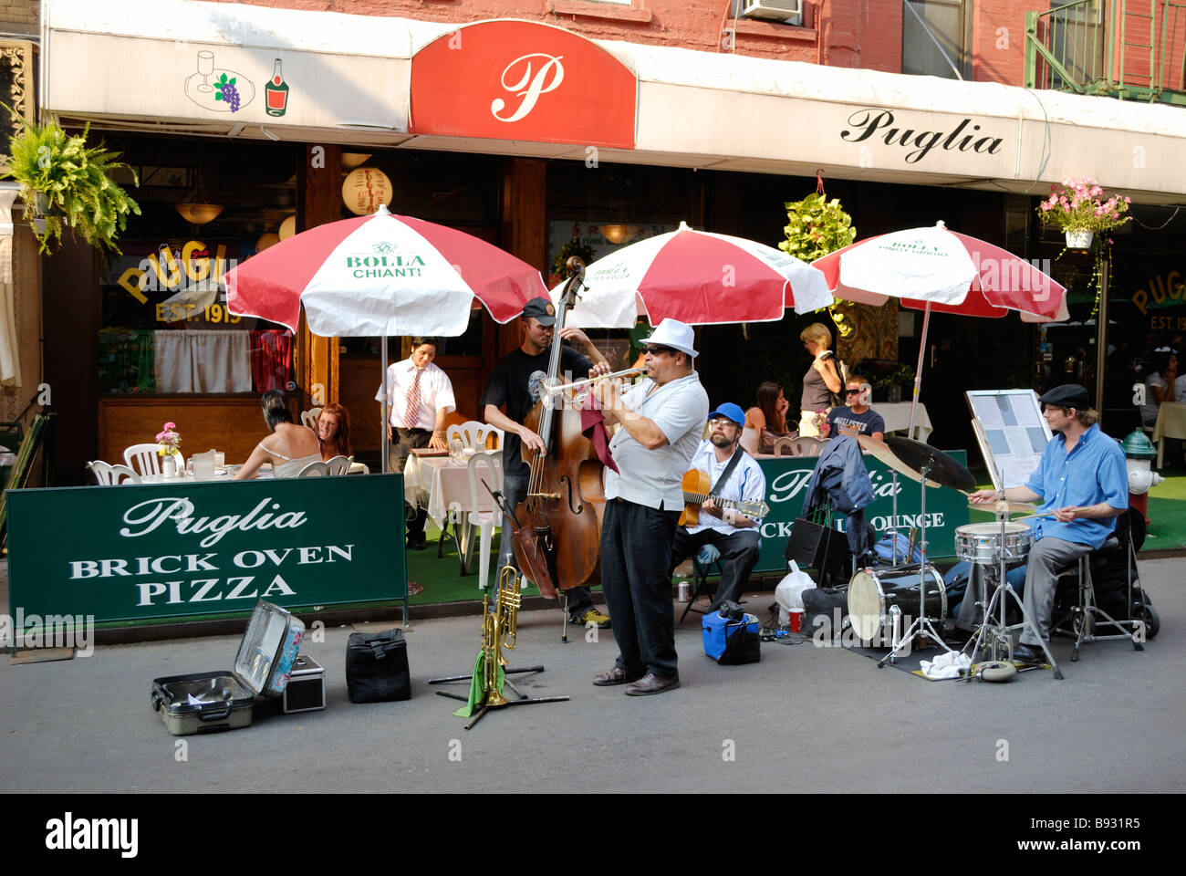 A small jazz combo of buskers playing on the street in Little Italy in New York City Stock Photo