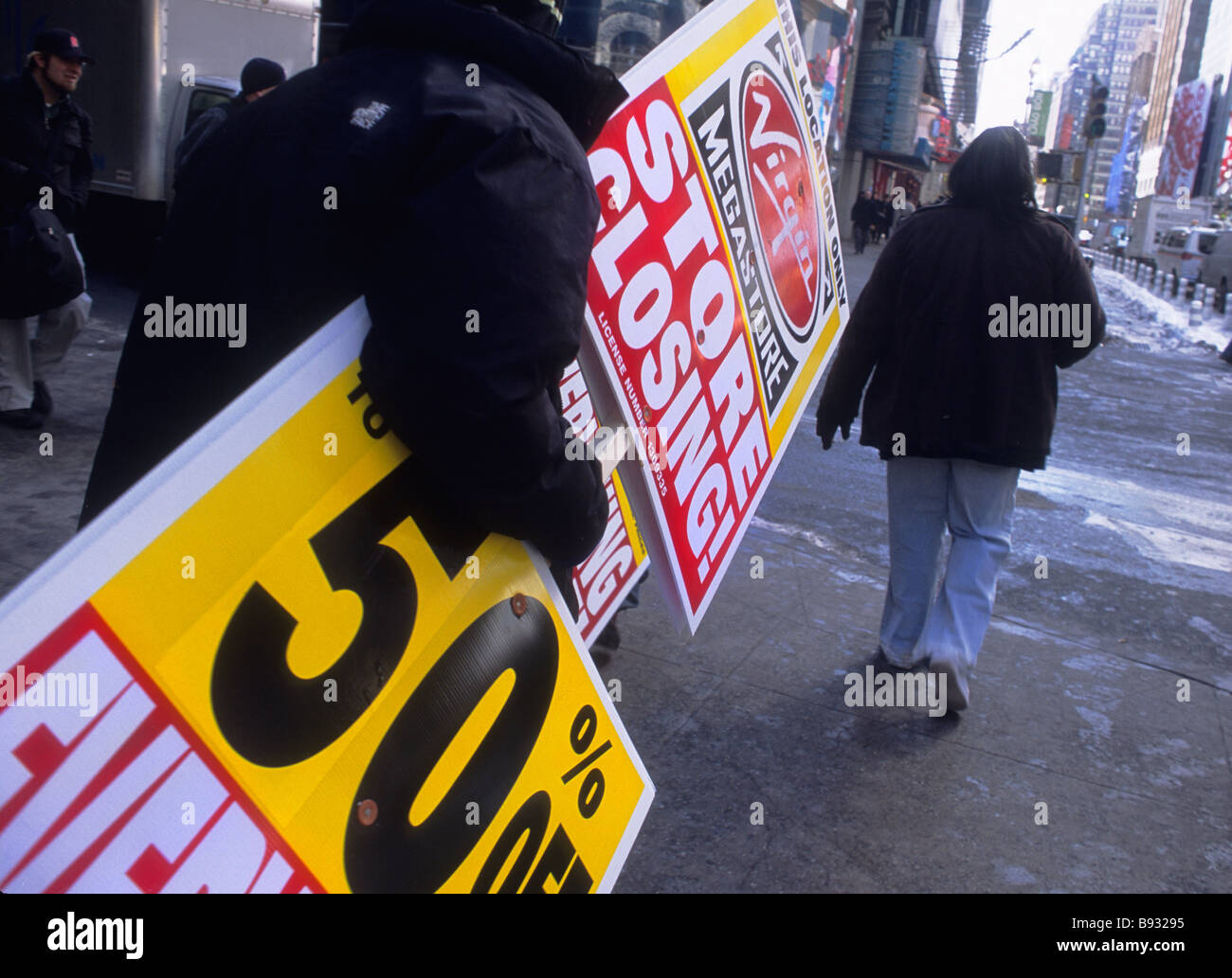 New York City Broadway and Times Square Man Carrying Going Out Of Business Sign Stock Photo