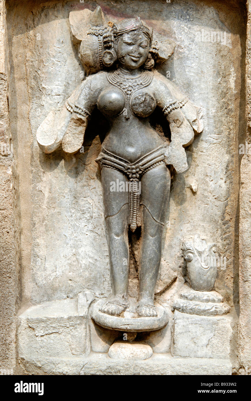 Hirapur Orissa, Yogini Temple, Yogini No.45. Stutee four armed figure mounting on a haladi kathua (pot for turmeric paste. Stock Photo
