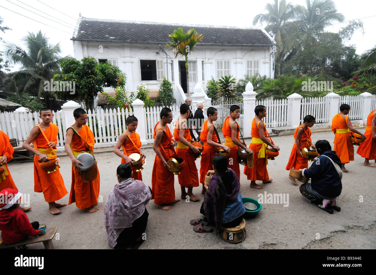 Monks collect alms Stock Photo