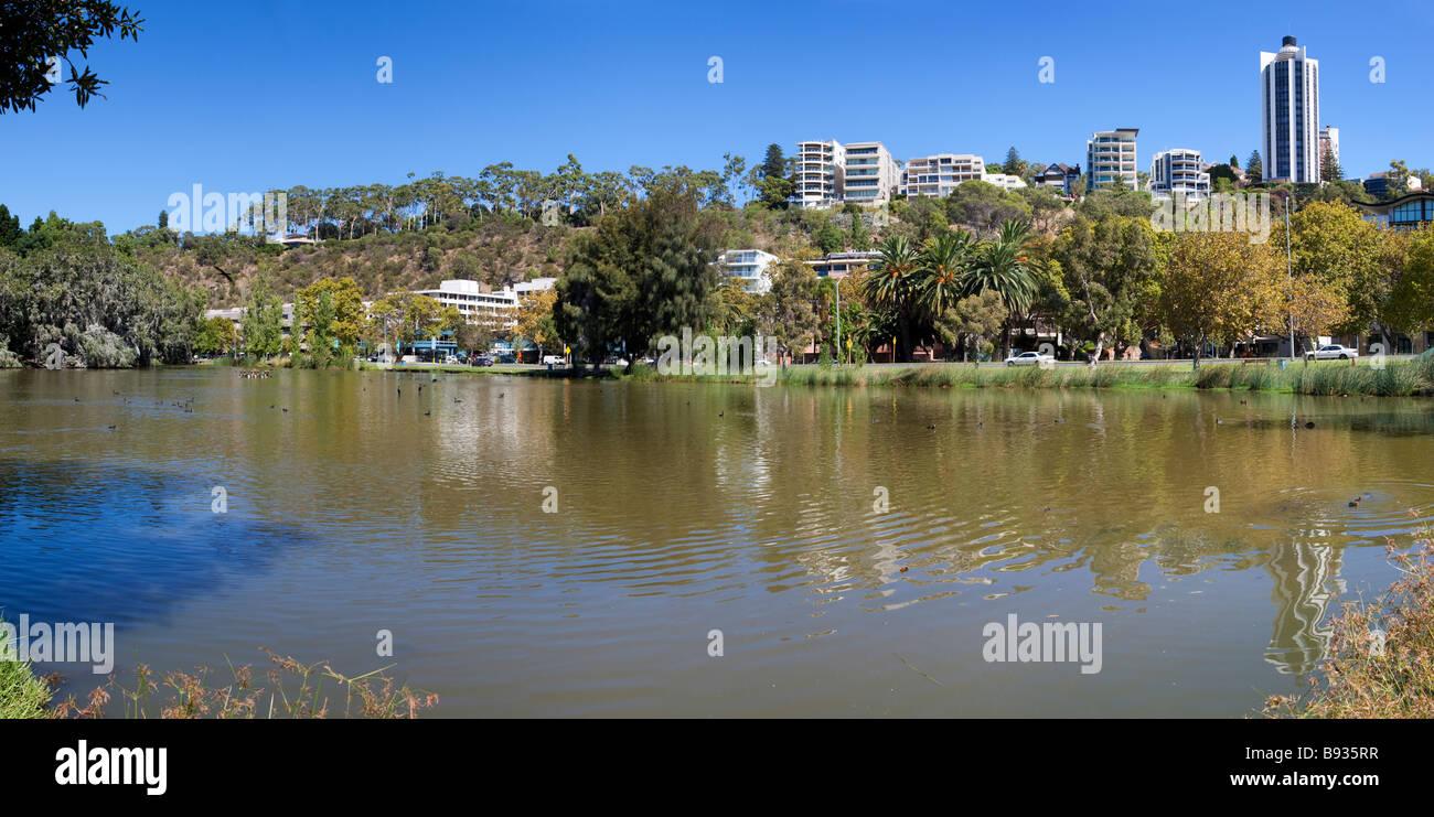King's Park and apartment buildings with a lake in the foreground. Perth, Western Australia Stock Photo