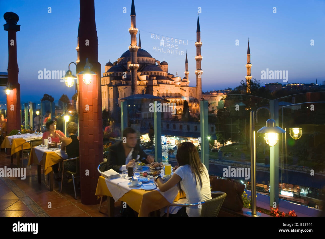 The Blue Mosque or Sultan Ahmet Mosque 1609 1616 rooftop restaurant dusk Sultanahmet District Istanbul Turkey Stock Photo