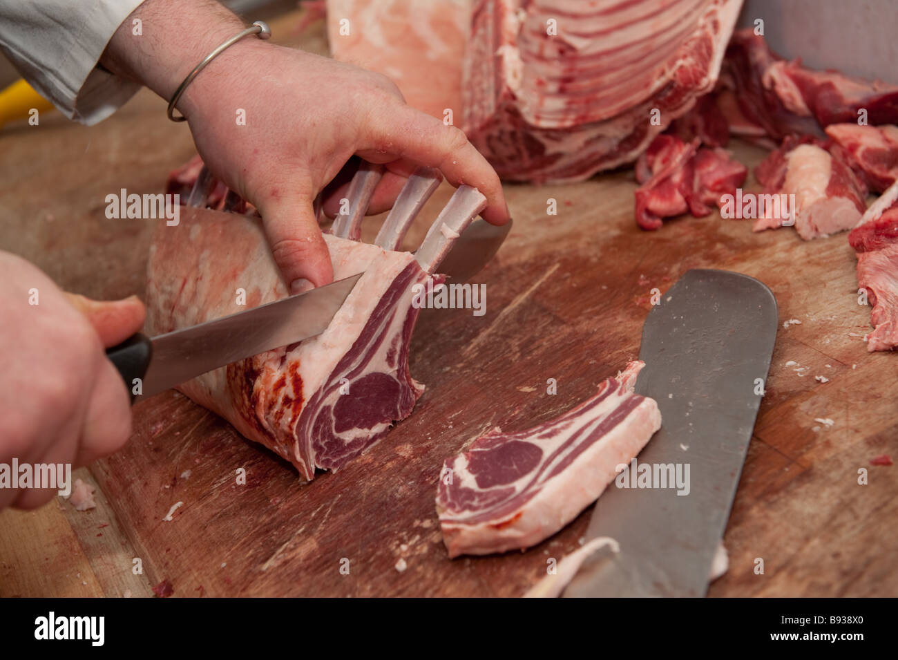 Rob Rattray award winning welsh butcher preparing fresh local lamb chops in his shop Aberystwyth Wales UK Stock Photo