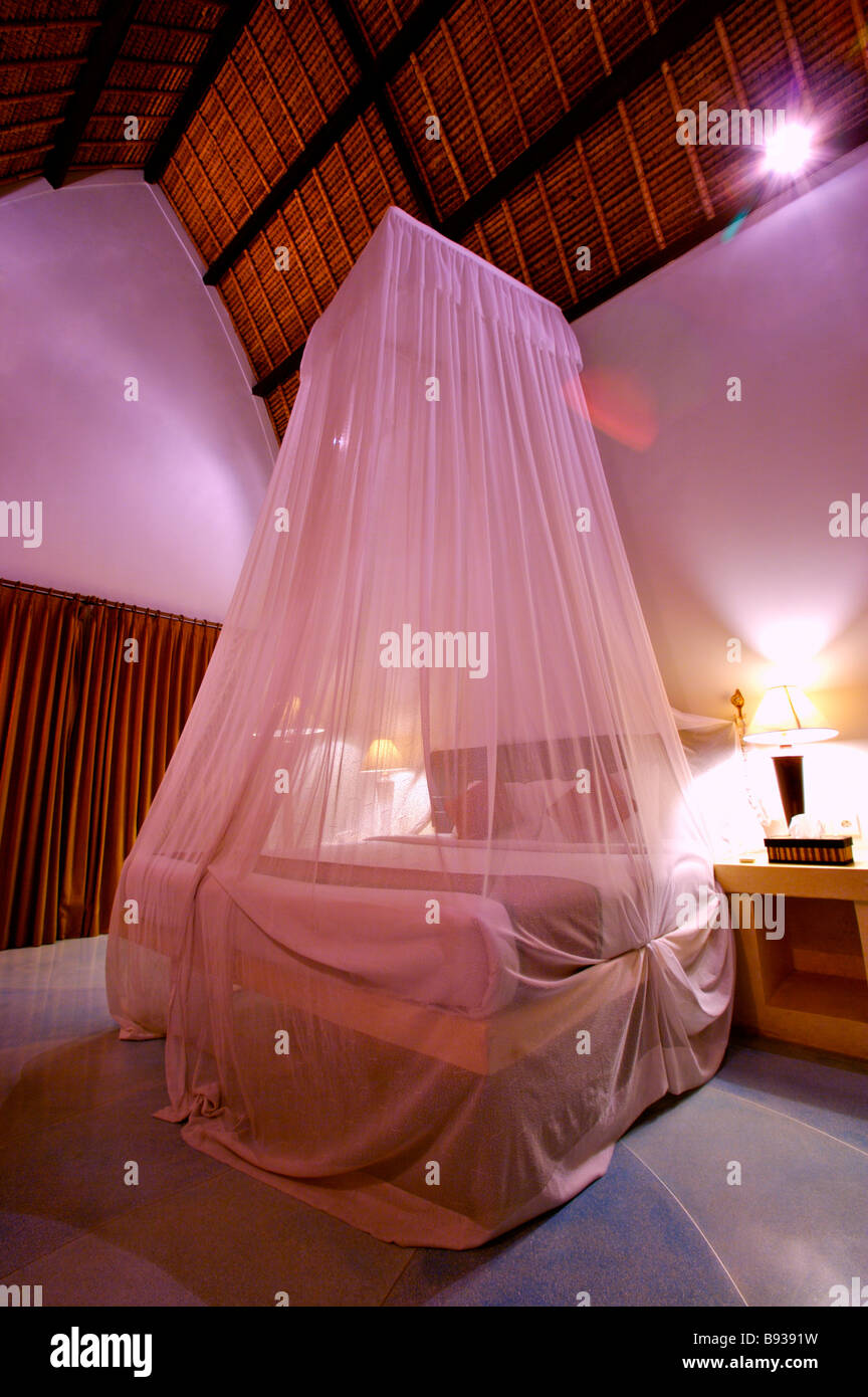 A romantic bedroom with curtain around bed Stock Photo Alamy