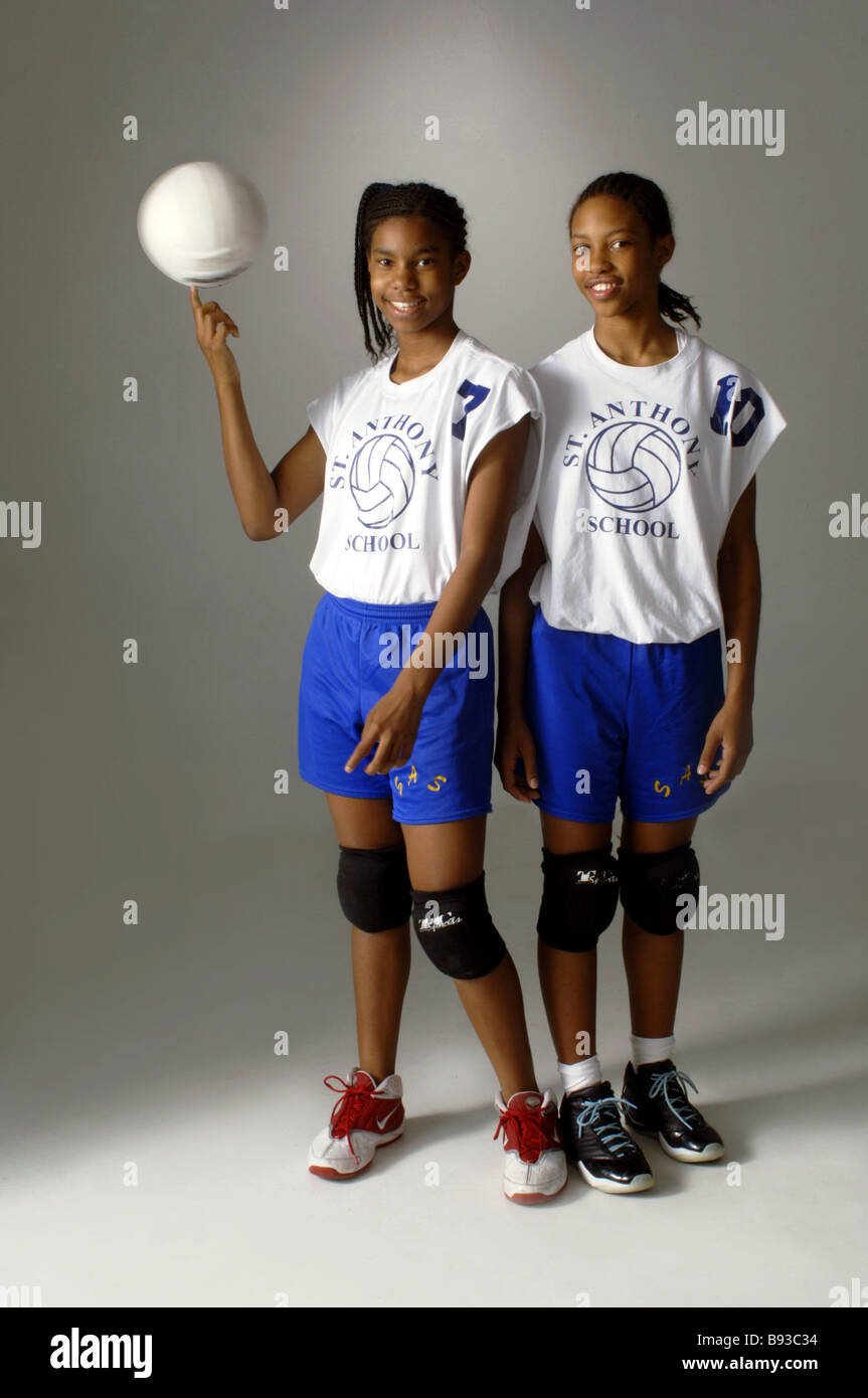 Sisters with volleyball catholic school uniforms, African American descent Stock Photo
