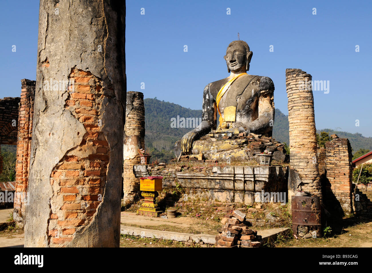 Buddha at Wat Phia Wat bomb damage destruction temple Stock Photo