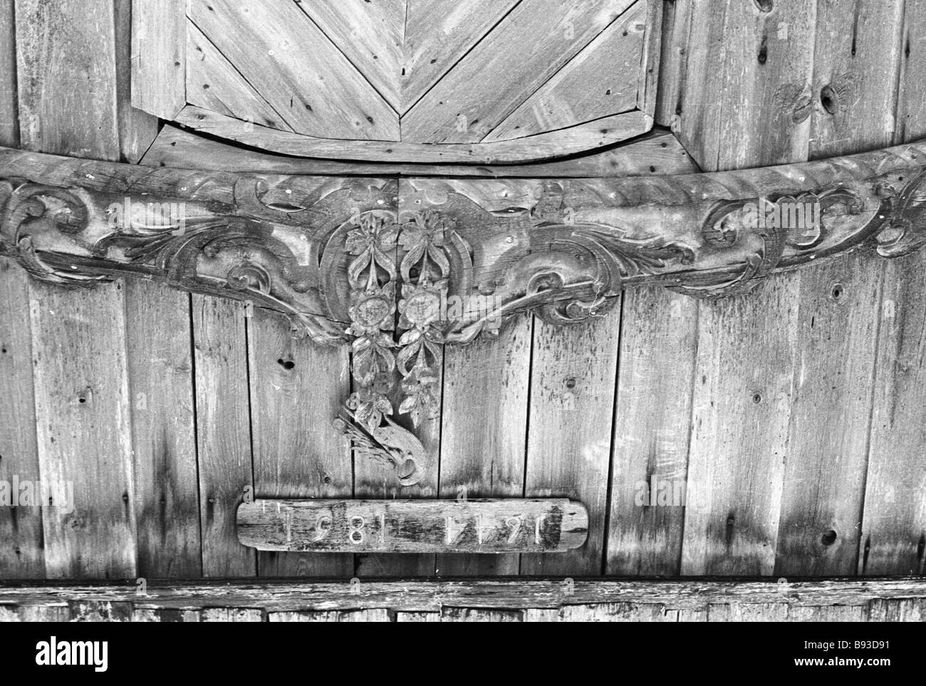 Carved piece above the entrance to the wooden church on Rukhnu Island Stock Photo