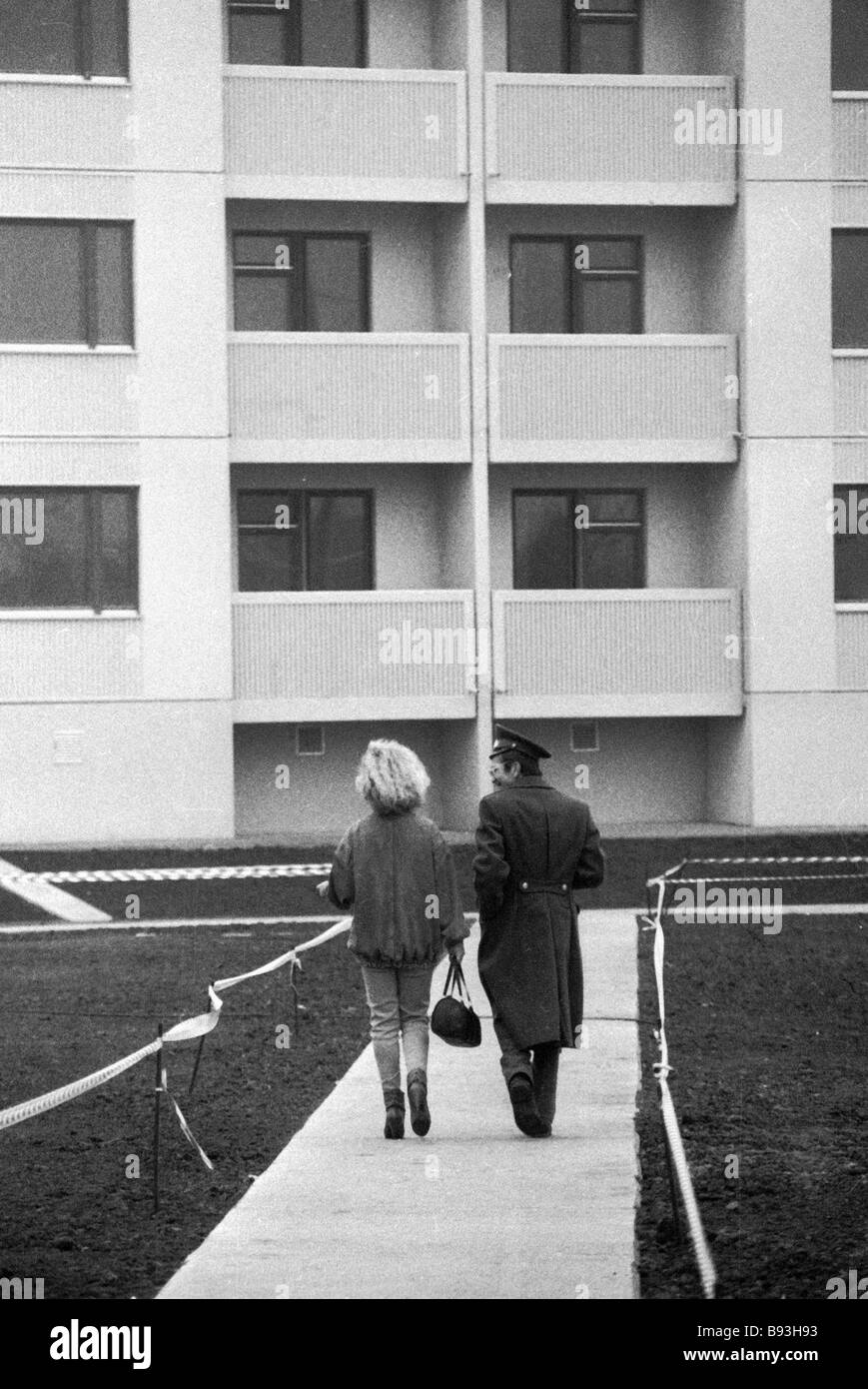 Military base residents walking toward new apartment house for military