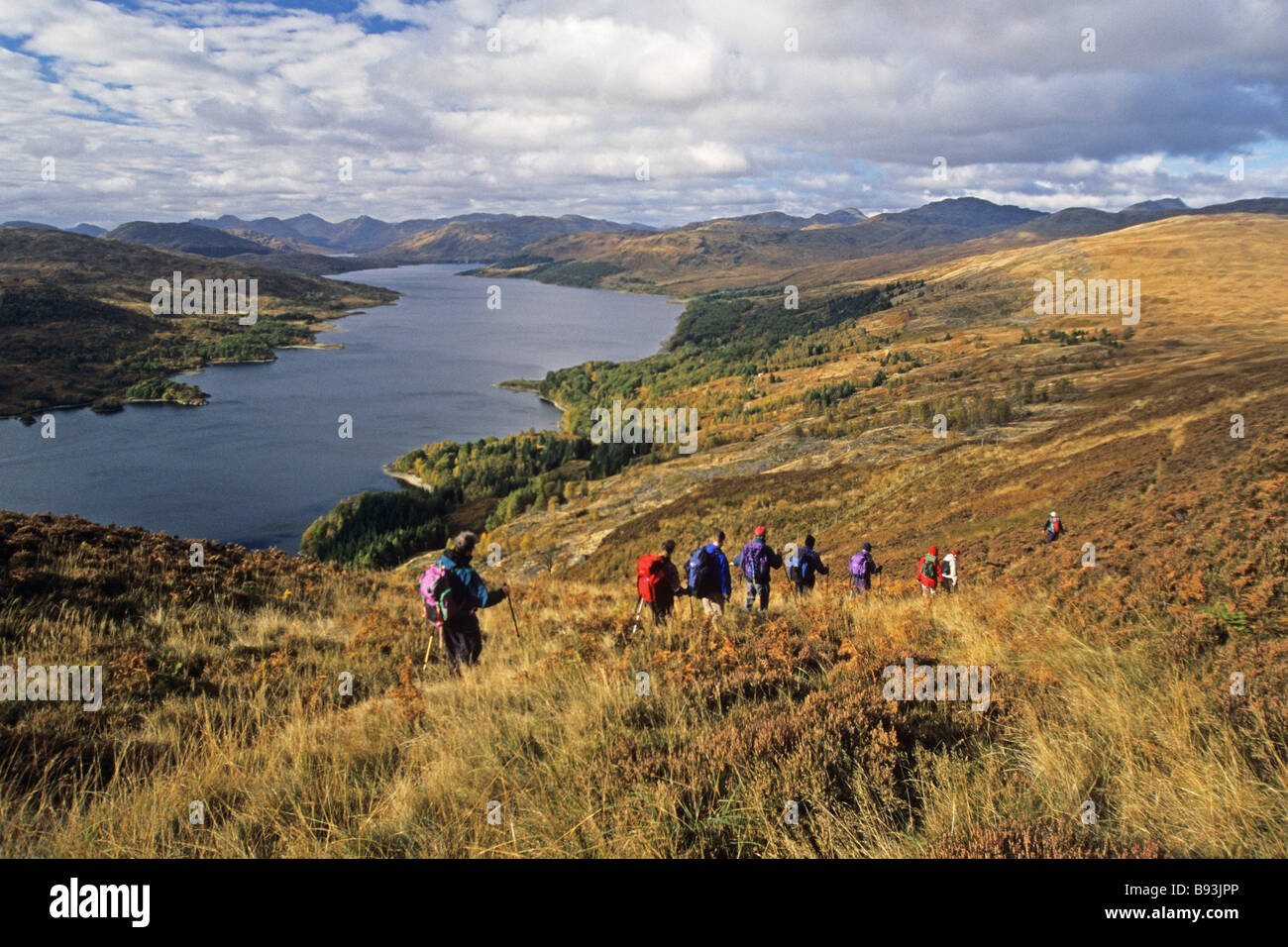 hillwalkers descending to Loch Katrine from Ben An Stock Photo