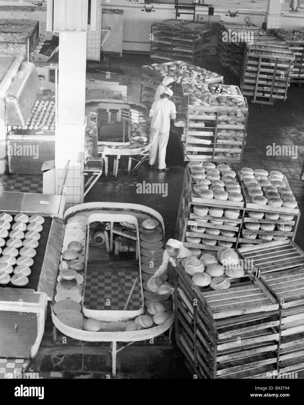 Workers at the end product room of a Moscow bakery put the bread onto ...