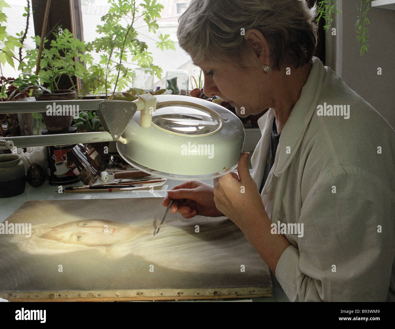 An artist restorer conserving pastel brushstrokes on parchment State