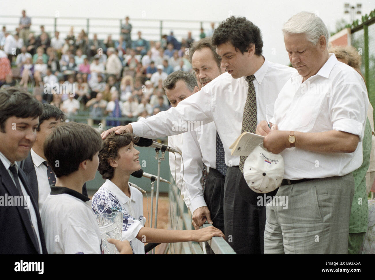 President Boris Yeltsin right giving an autograph to a young tennis