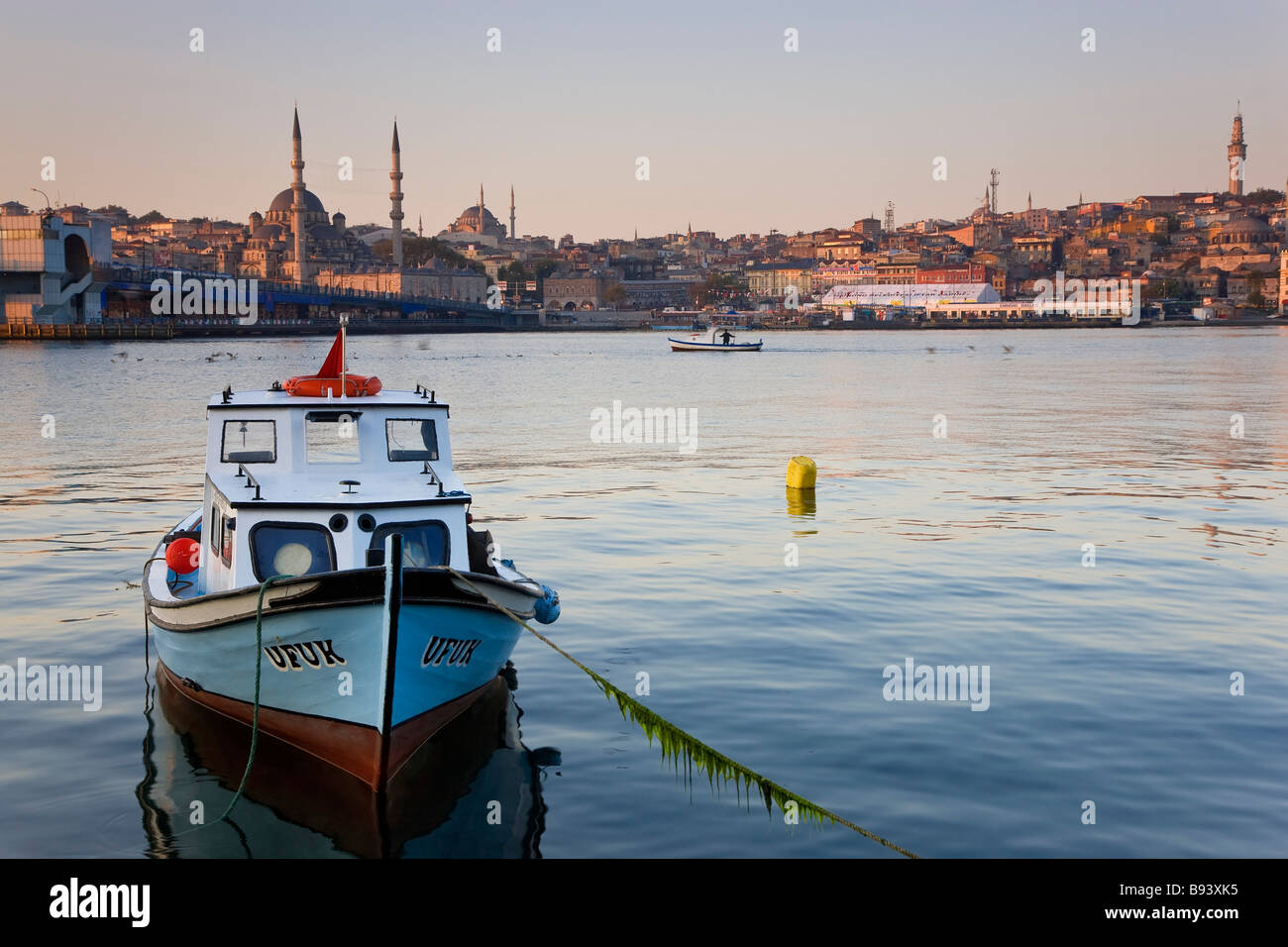 Boat on The Bosphorus mosque on skyline Istanbul Turkey Stock Photo