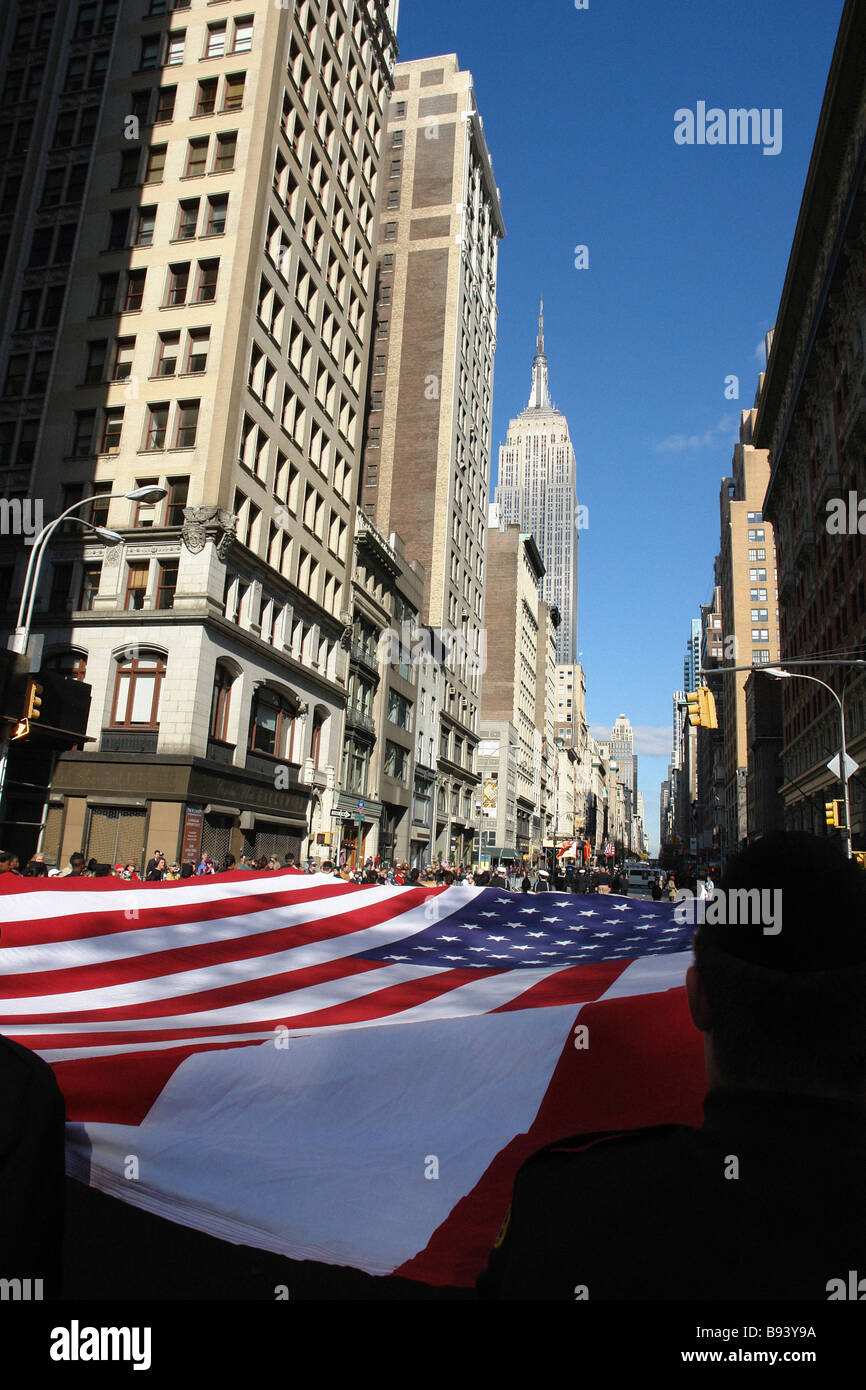 Large USA America flag being carried by many people at Veterans Day Parade in New York City USA Stock Photo