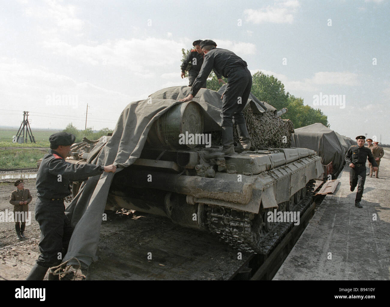 Soldiers camouflaging the tank during Carpathian Military District ...
