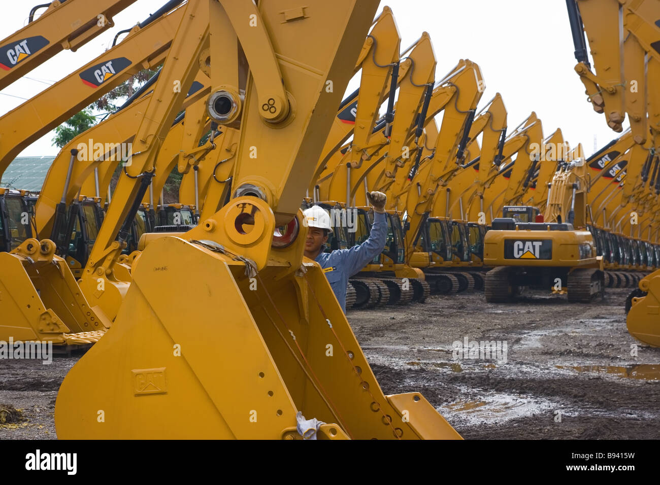 an engineer working on installation of a bucket of a caterpillar