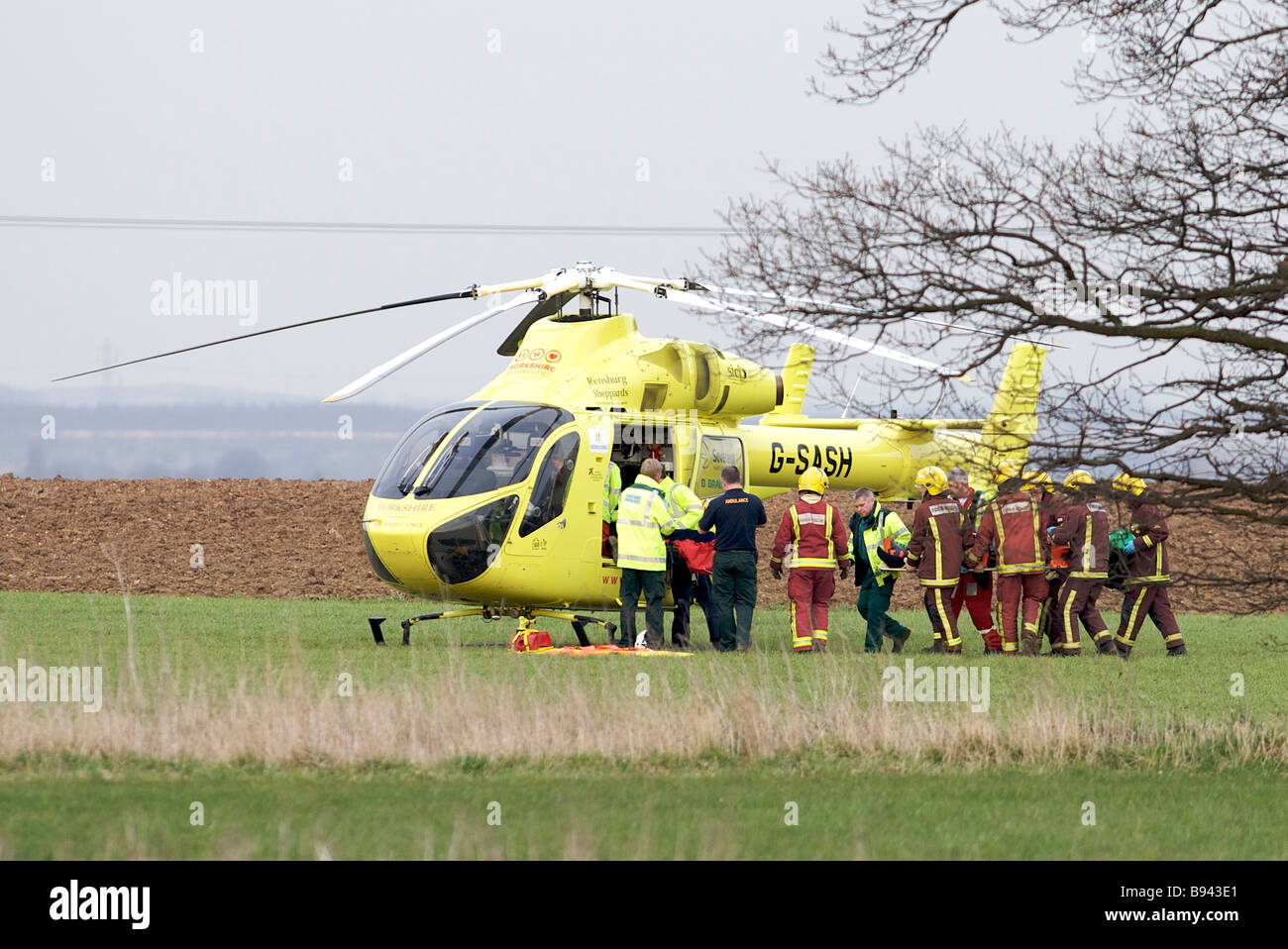 Yorkshire Air Ambulance MD 902 Explorer helicopter G-SASH surrounded by Paramedics and South Yorkshire Fire and Rescue. Stock Photo