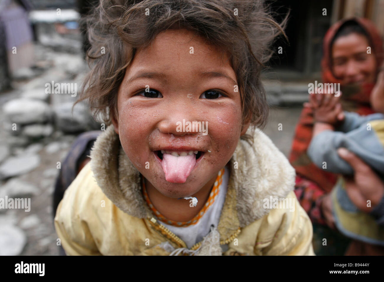 Annapurna Nepal 20 March 2008 Funny little poor kid sticking his tongue out at trekkers Stock Photo