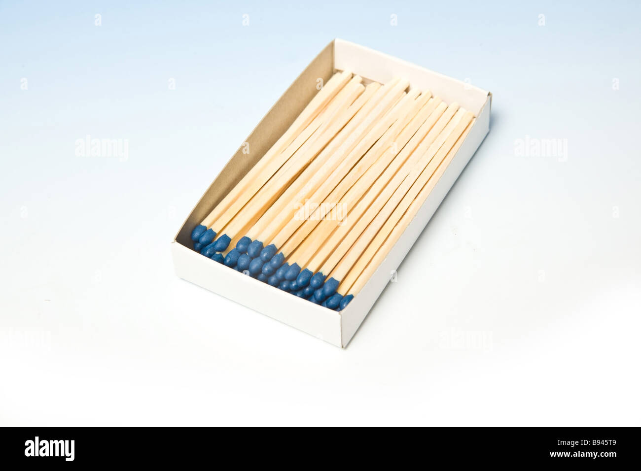 Box of matches on a graduated blue studio background. Stock Photo