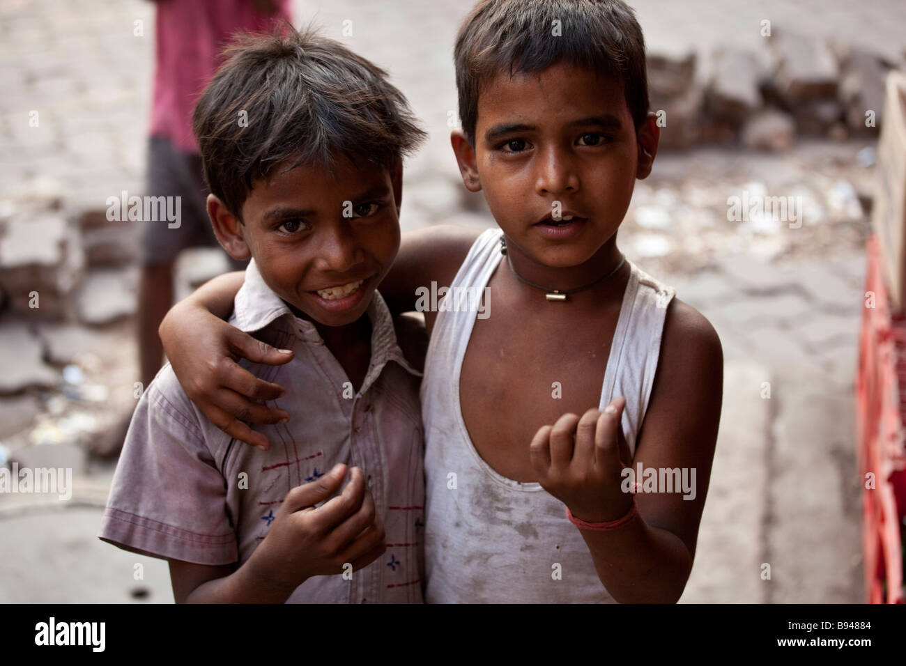 Two Poor Homeless Boys Begging in the Streets of Calcutta India Stock Photo
