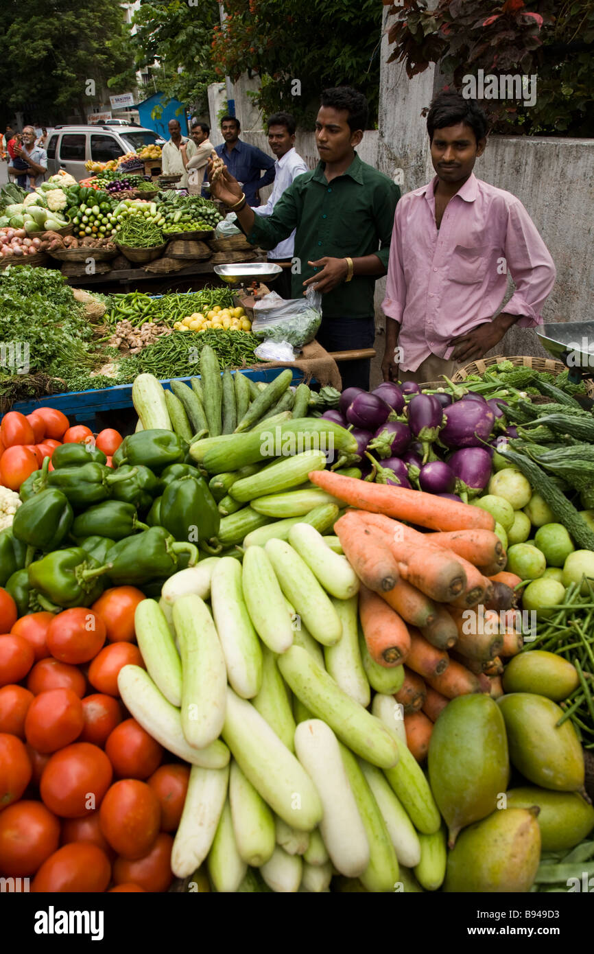 Street market seller with his top quality fresh fruit and vegetables. Street market stall, Surat, Gujarat. India. Stock Photo