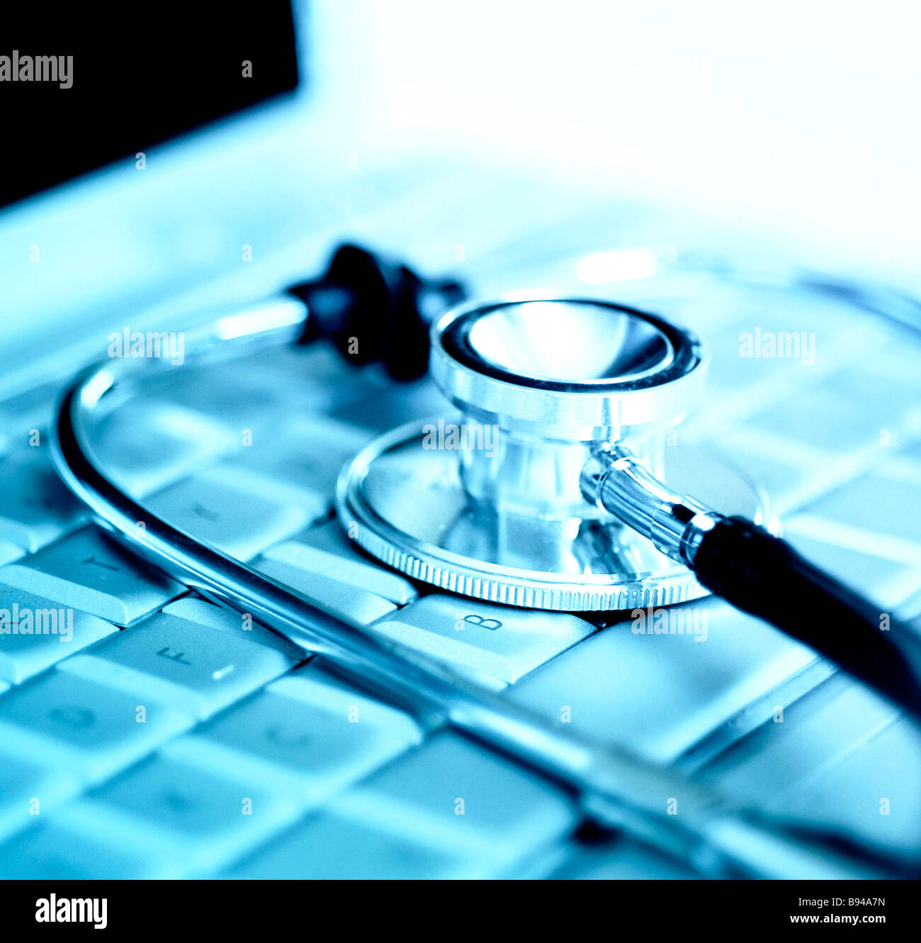 Stethoscope over laptop keyboard Stock Photo