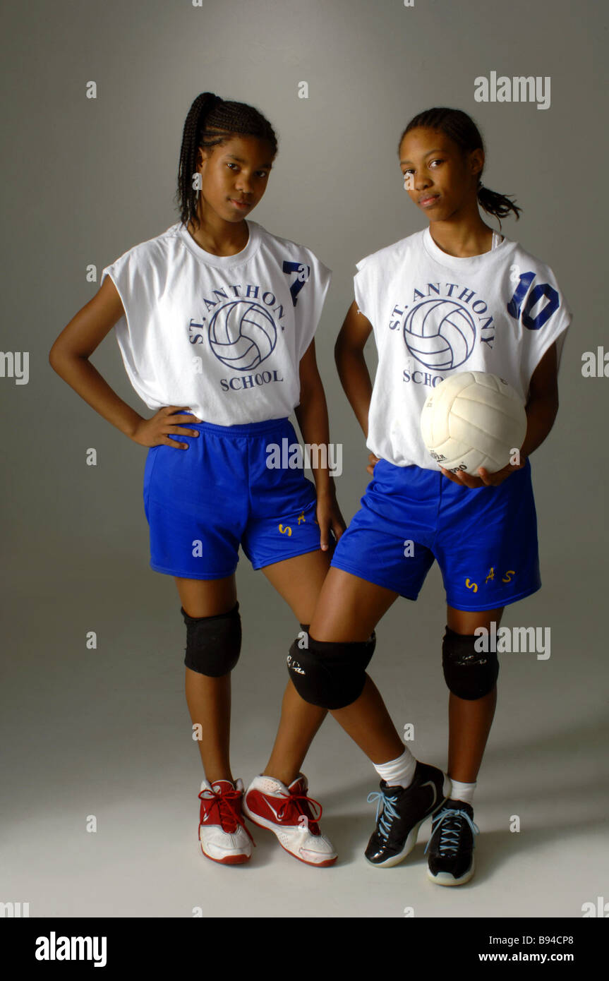 Sisters with volleyball catholic school uniforms, African American descent Stock Photo
