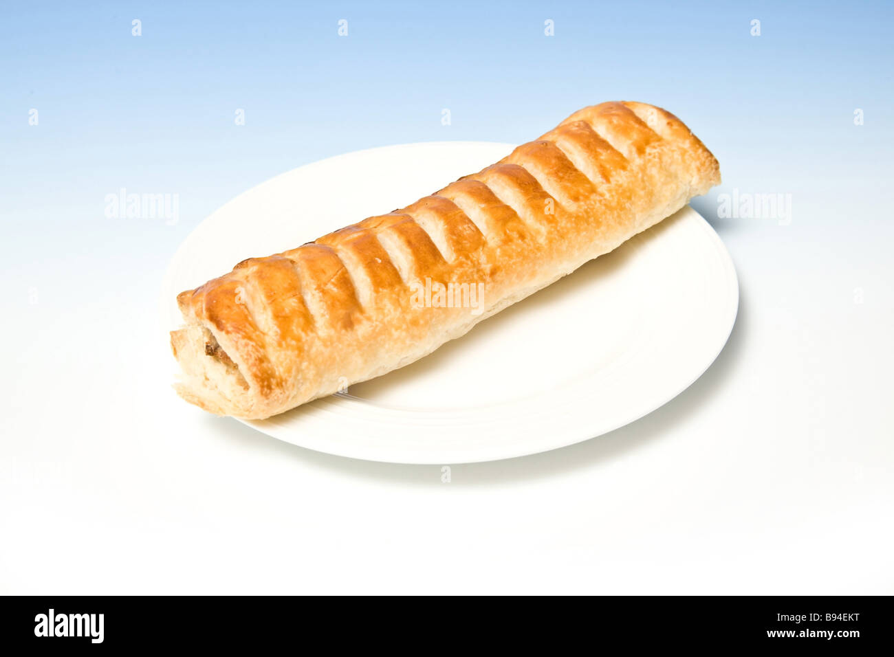 Jumbo Sausage roll on a white plate Stock Photo Alamy