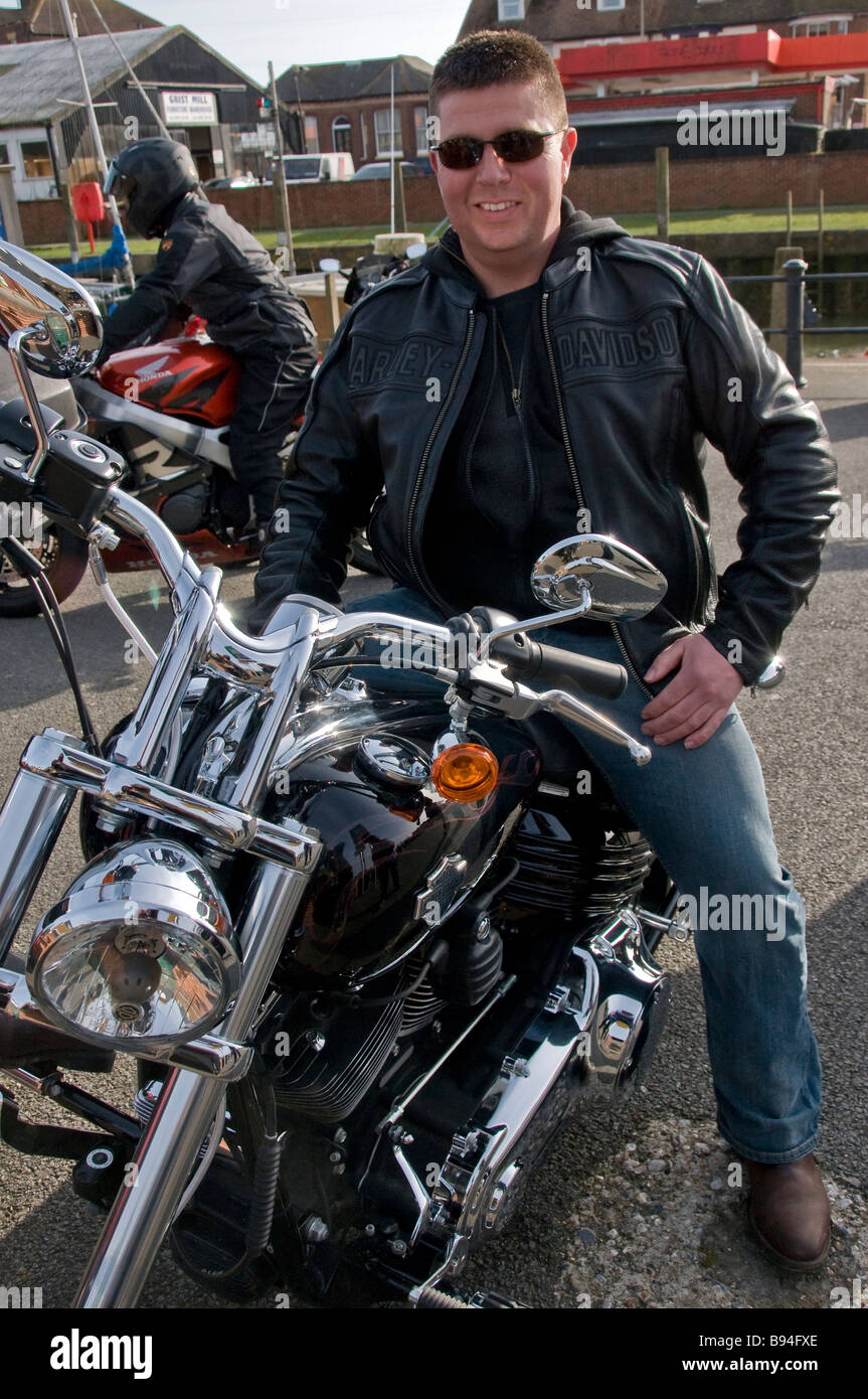 A Harley Davidson Rider Wearing A Black Leather Jacket And Dark Sunglasses Looking At The Camera Rye East Sussex England Uk Stock Photo Alamy