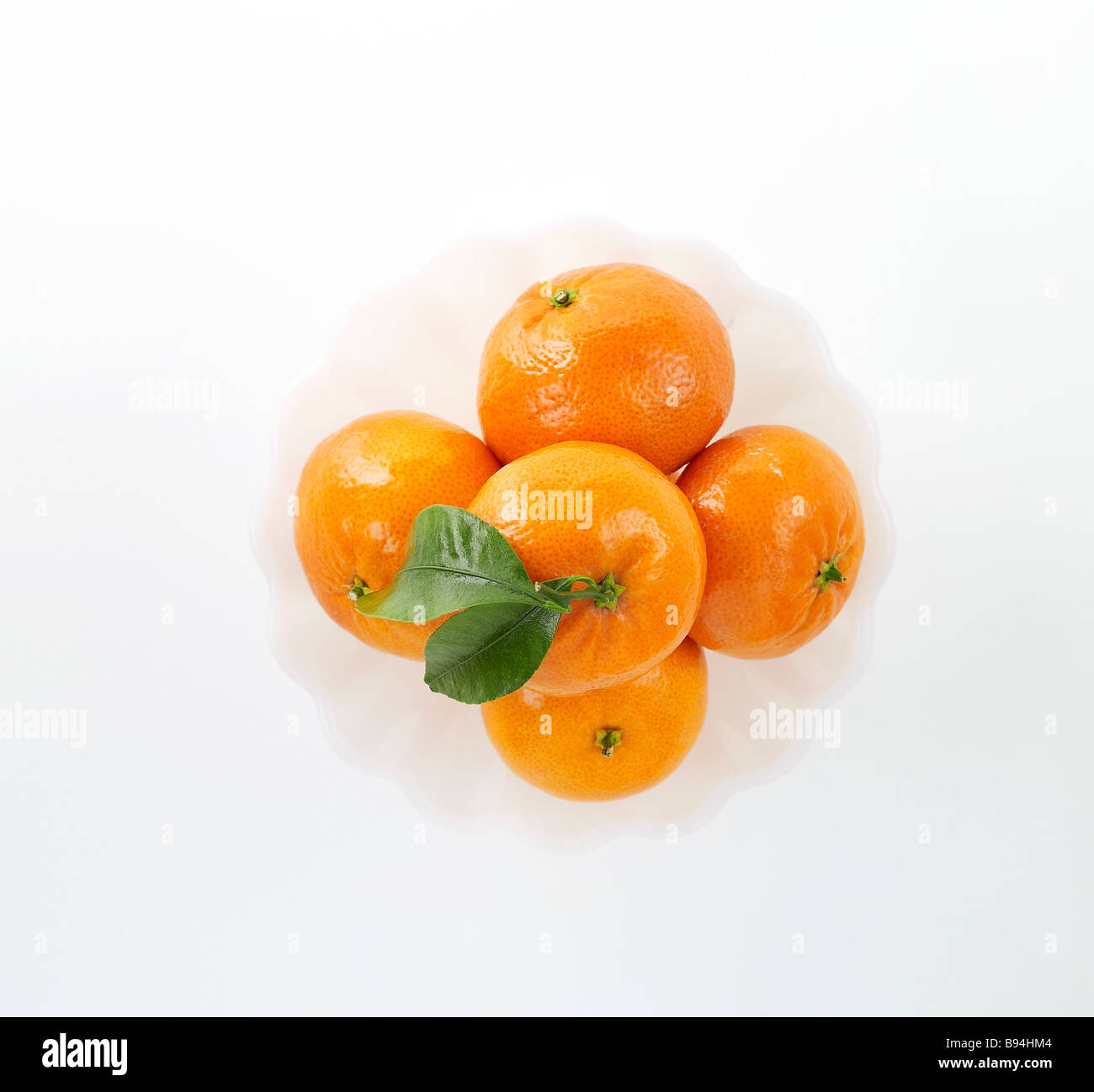 Mandarin Oranges in a bowl on white background Stock Photo