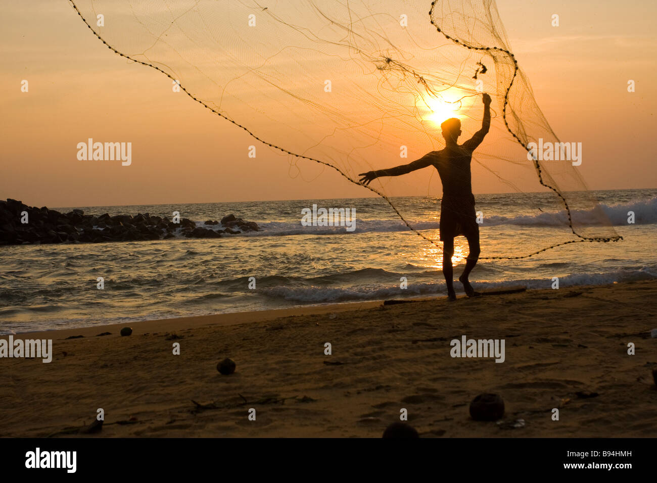 Indian fisherman throwing nets, Kerala Stock Photo