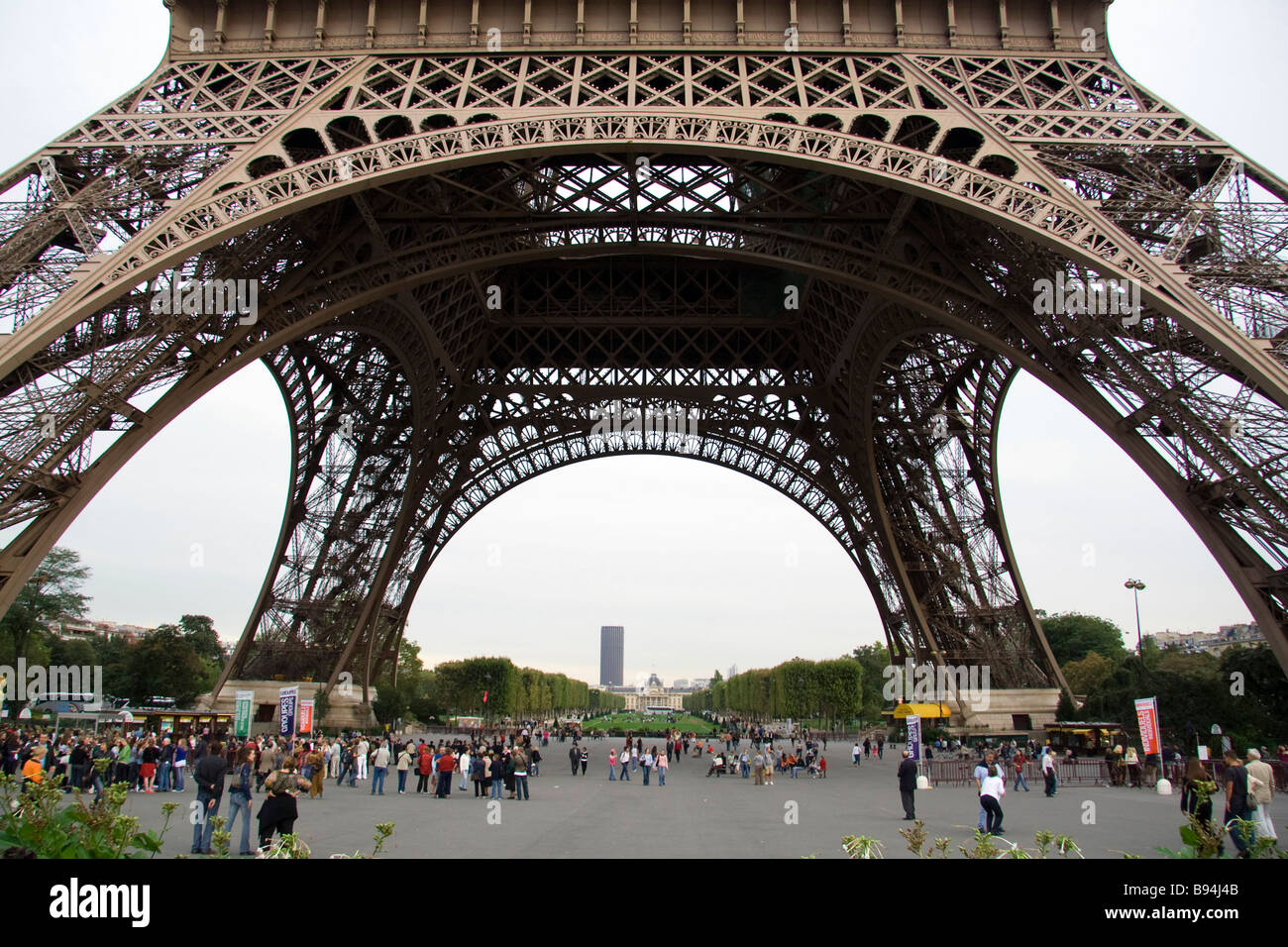 Eiffel Tower Base With Tourists And Sightseers Gathering And Queuing To eiffel-tower-base-with-tourists-and-sightseers-gathering-and-queuing-to
