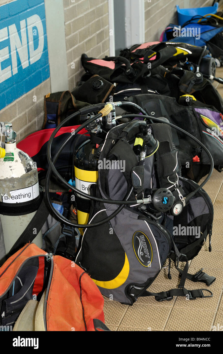 Scuba diving equipment lined up along pool side Stock Photo