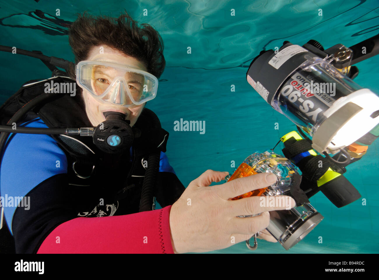 Woman scuba diver underwater with camera Stock Photo