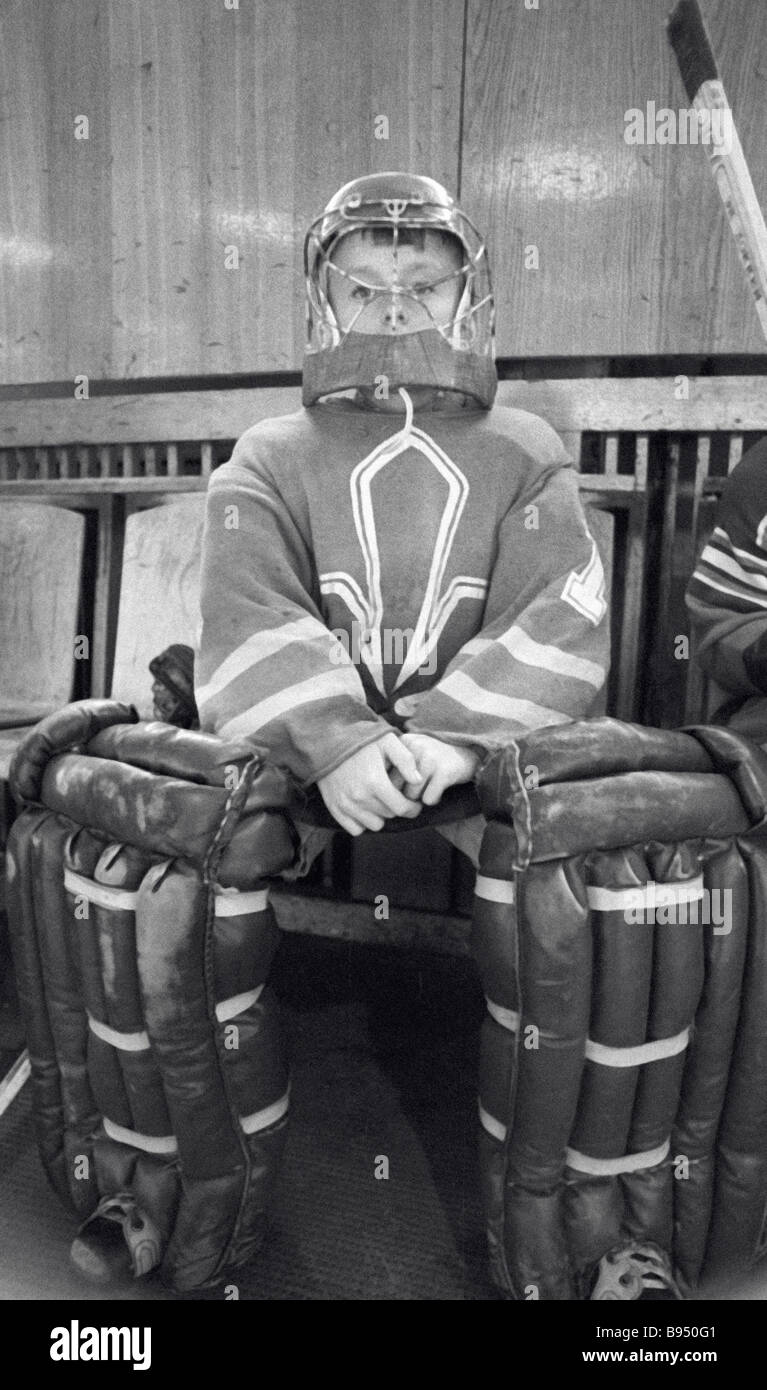 A young hockey player on the reserve bench Stock Photo Alamy