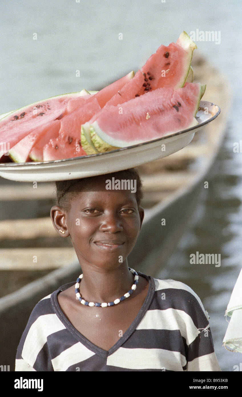 A boy carrying a tray with cut water melon on his head Stock Photo Alamy