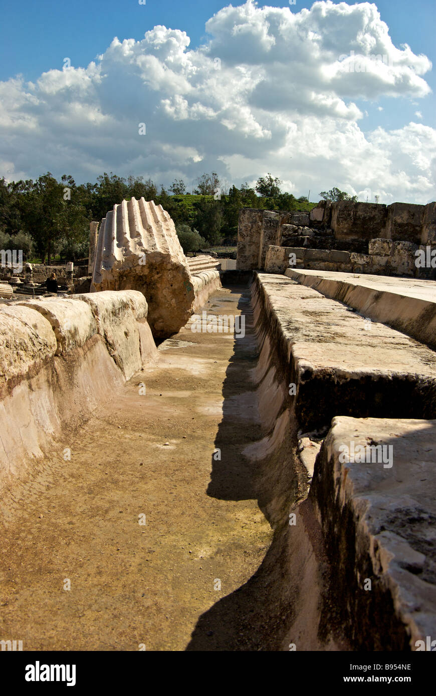 Earthquake toppled building columns debris ruins and upheaved steps floors in archaeological excavation site at Bet She an Stock Photo