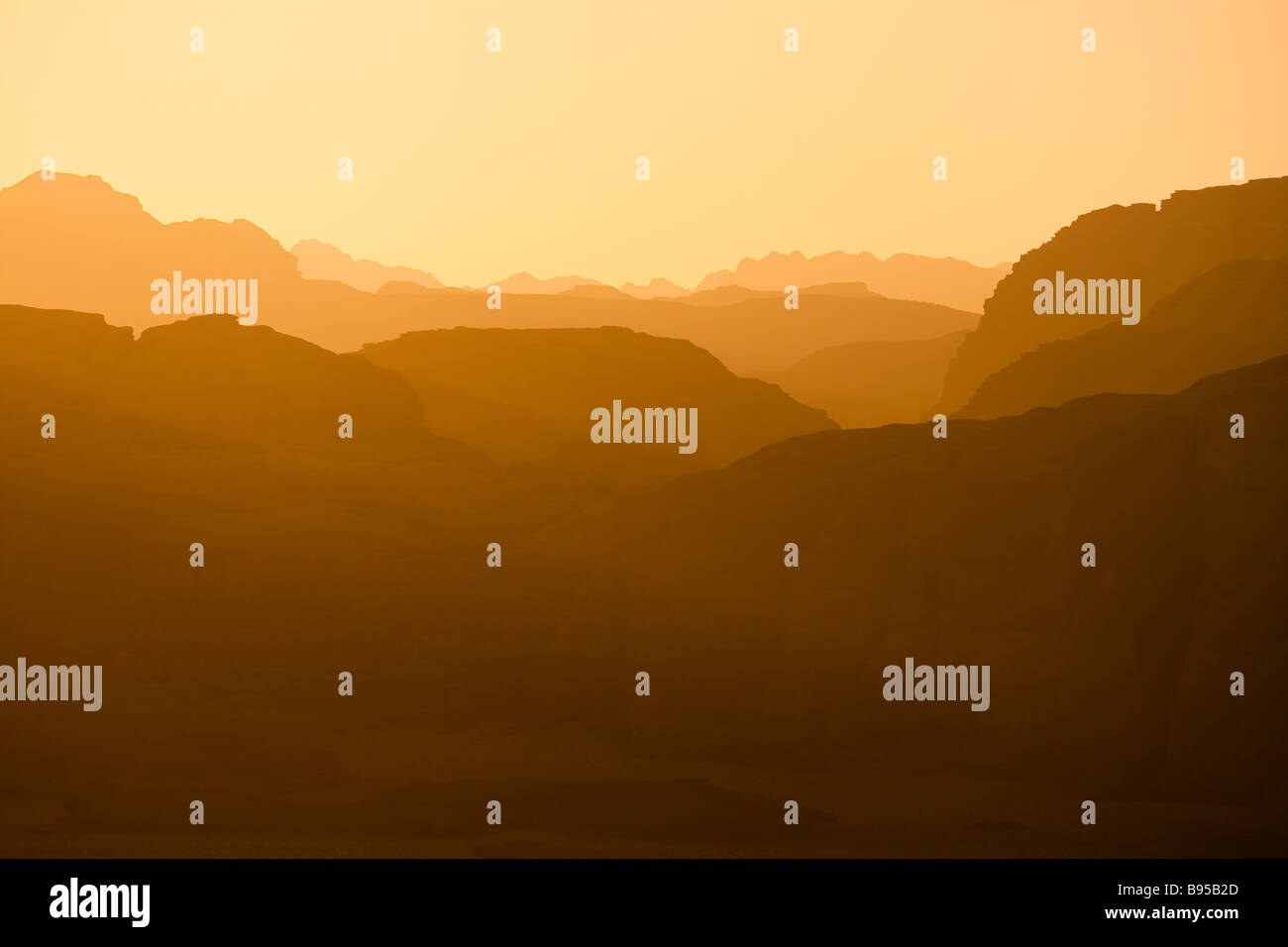 Distant mountains lit by the setting sun in the Wadi Rum desert reservation Jordan Stock Photo