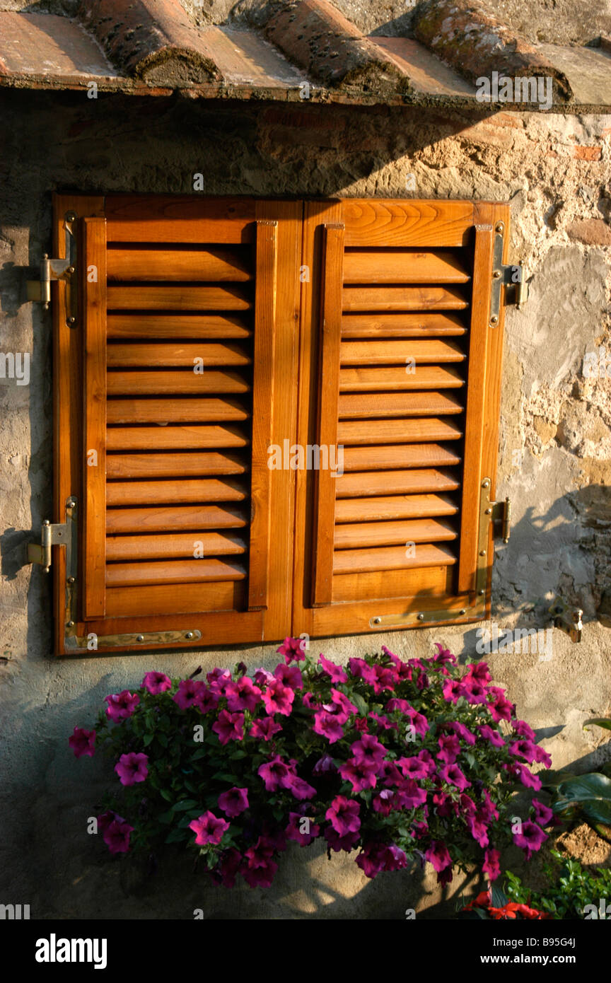 A shuttered window to prevent the heat of the day entering a house. Stock Photo