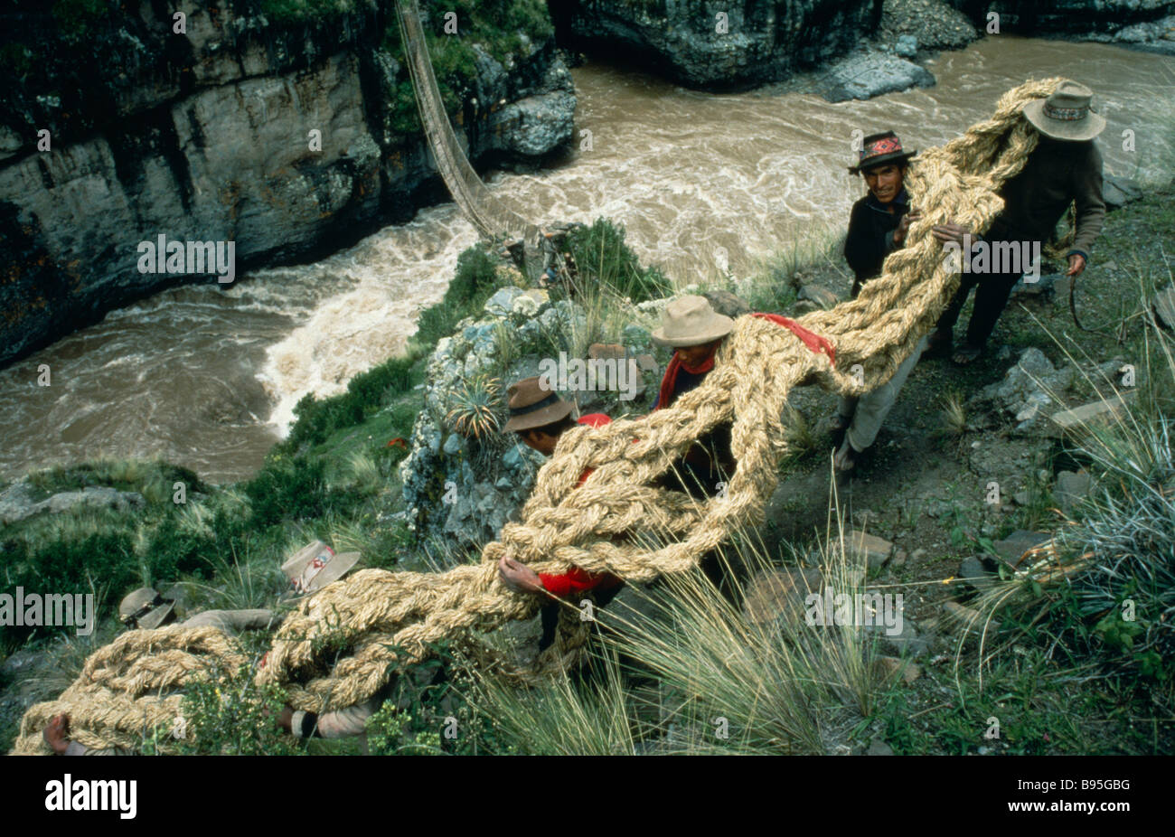 PERU Apurimac River Chumbivilcas Hills men carrying thick grass