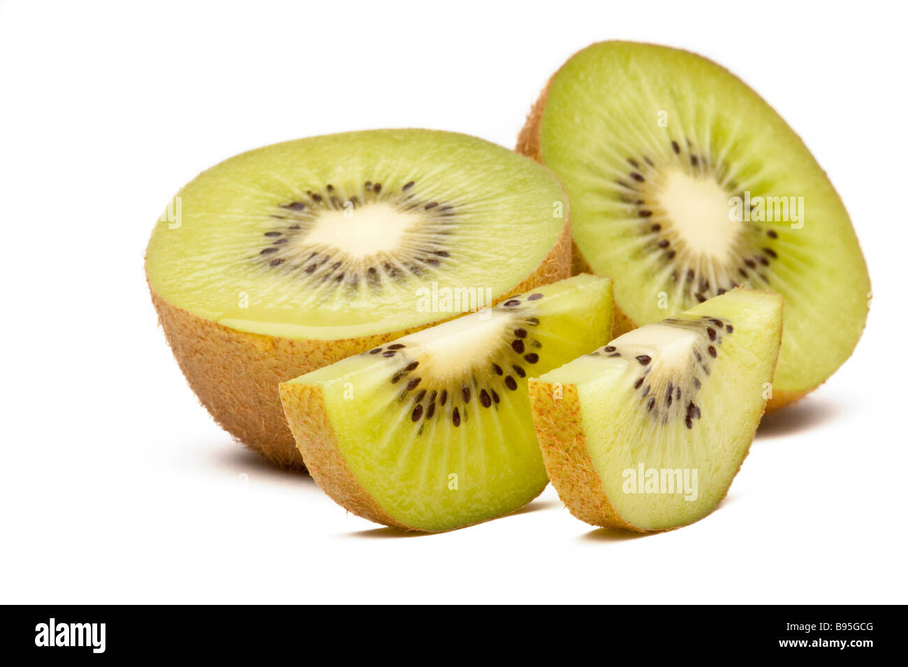 Green kiwi or kiwifruit halved and sliced Stock Photo