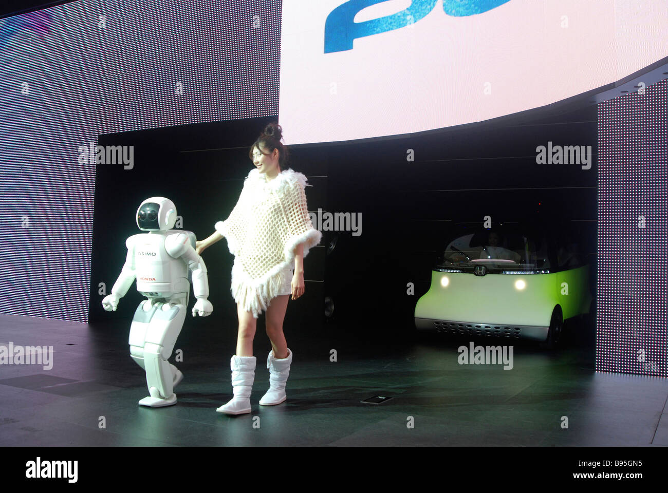JAPAN Honshu Chiba Tokyo Car Show Asimo Robot and young woman introduce Honda concept car Puyo. Stock Photo